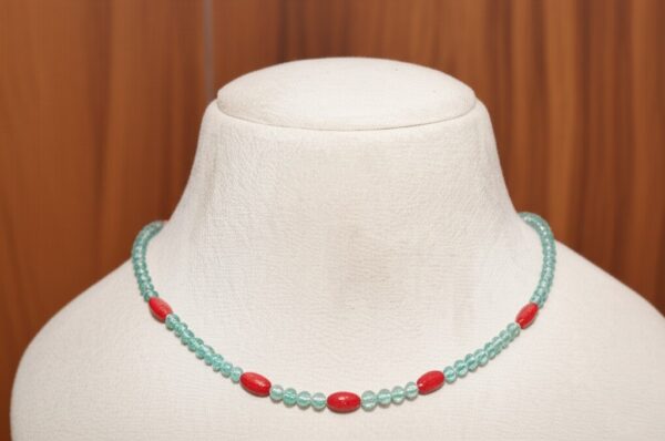 This delicate and vibrant necklace by Kozzah is crafted with natural apatite beads accented by vivid red coral-style beads. The design perfectly balances the cool oceanic hues of apatite with bold pops of red, creating a statement piece that exudes elegance and energy. This lightweight, 20-inch necklace is ideal for layering or wearing alone to add a touch of sophistication to any look.